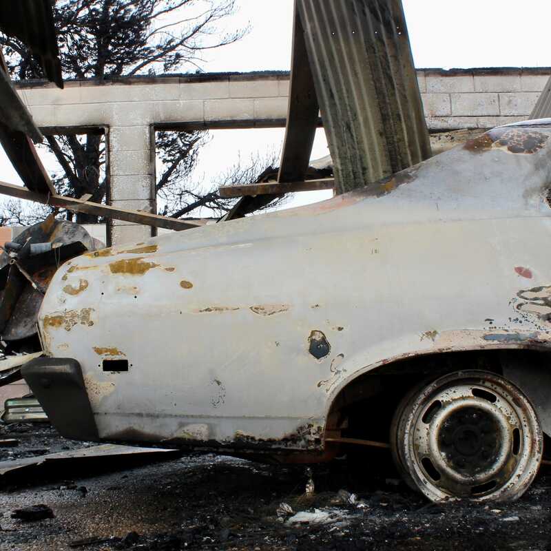 A fire-damaged car sits in front of a burned-out structure Thursday, Feb. 29, 2024, along State Highway 136 between Fritch and Borger in the Texas Panhandle. The Windy Deuce Fire burned through the area and caused the damage.